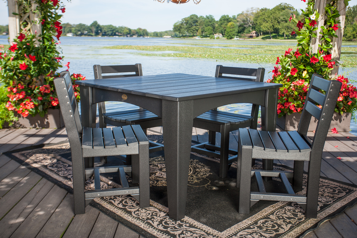 Island dining table set in black on a patio