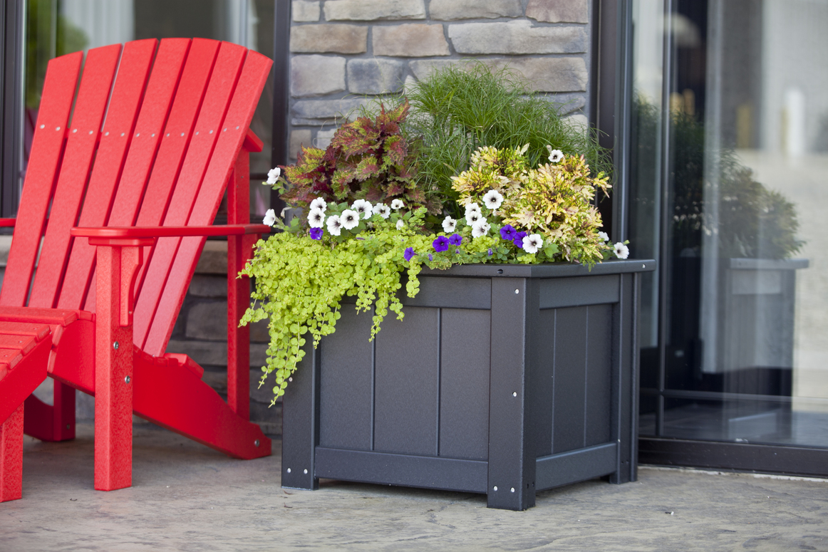 Black poly planter displayed in an outdoor setting